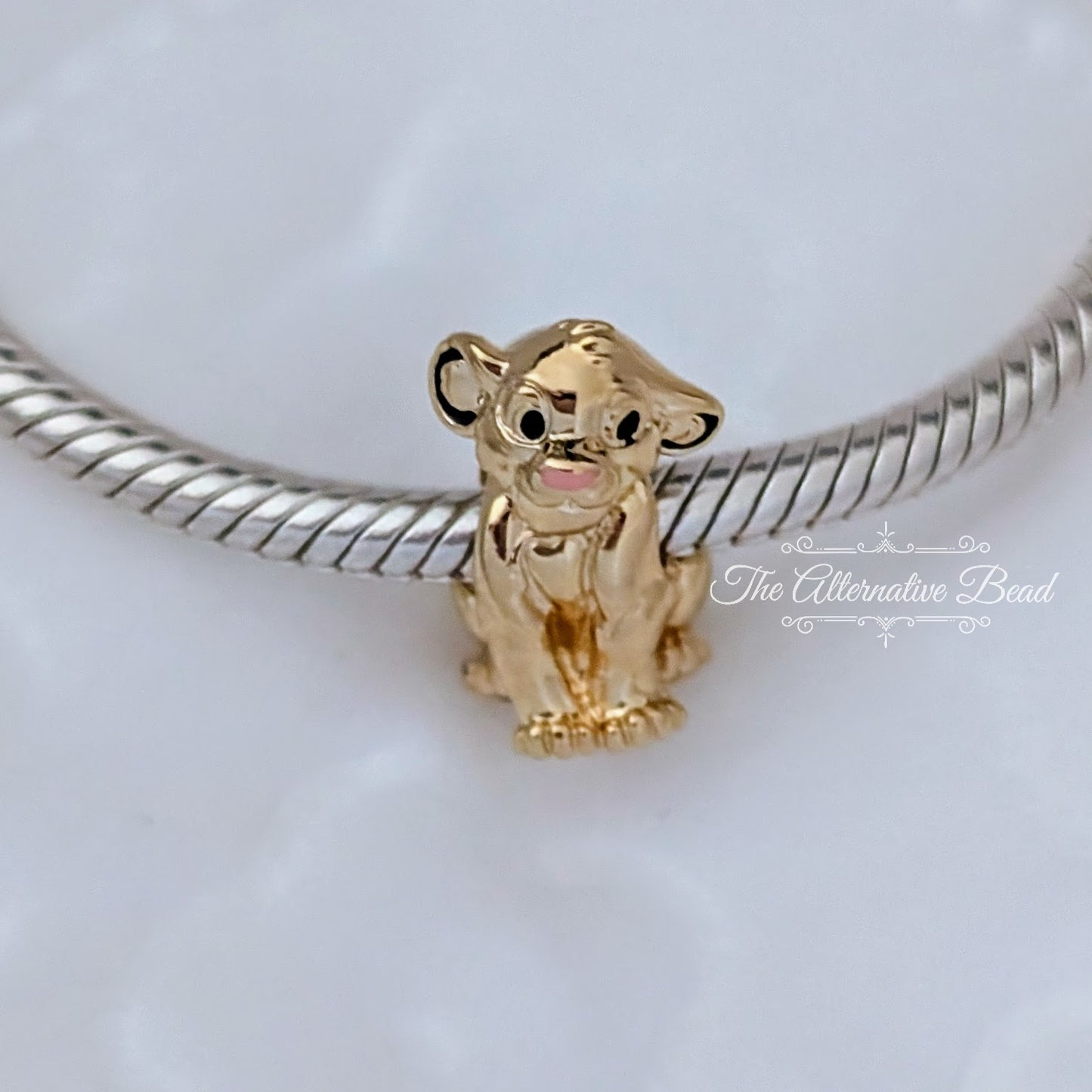 Disney x Pandora Simba Gold Plated Slide Charm gold sterling-silver; gold Bead by The Alternative Bead. Your official Disney x Pandora Retailer from Germany