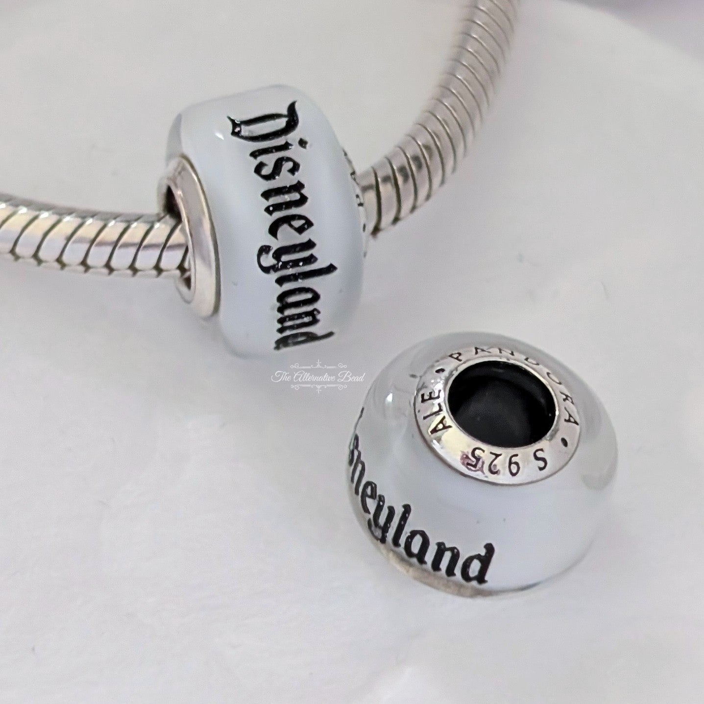 Disney x Pandora Disneyland Glass bead Charm silver and white sterling-silver and glass Bead by The Alternative Bead. Your official Disney x Pandora Retailer from Germany