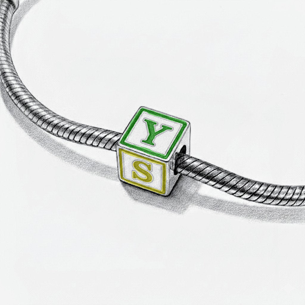 Bracelet with a charm shaped like a green and white block with 'YES' on it.