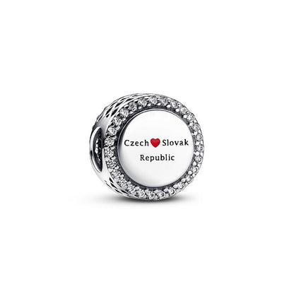 Silver charm with 'Czech Slovak Republic' text on a white background