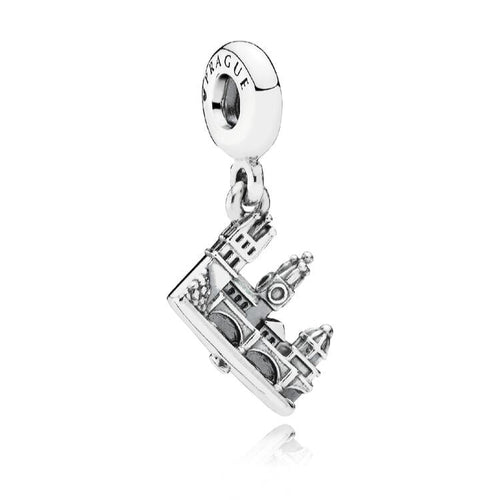 Silver charm with a detailed design on a white background