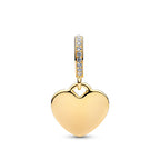 Gold heart-shaped pendant with clear gemstones on a white background