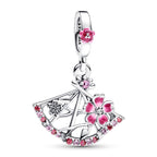 Silver pendant with pink floral designs on a white background