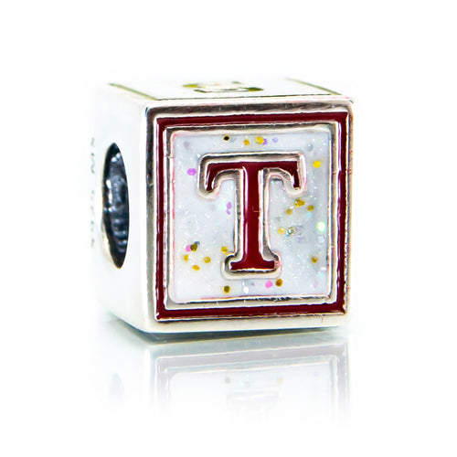 Cube-shaped charm with letter 'T' on a white background