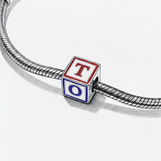 Bracelet with a cube charm featuring the letters 'T' and 'O' on a geometric background